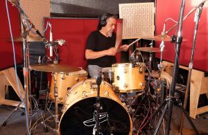 rock drummer performing in a recording session